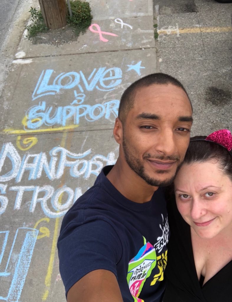 Josie poses with artist in front of #TorontoStrong artwork