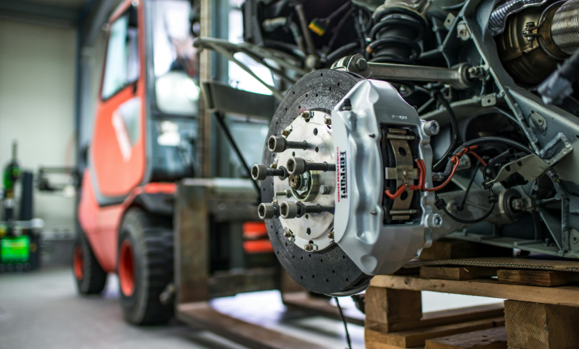 An automotive brake calliper and disc in an industrial workshop
