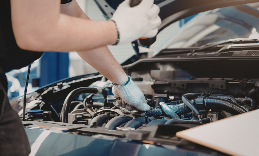A mechanic working on a car engine repair